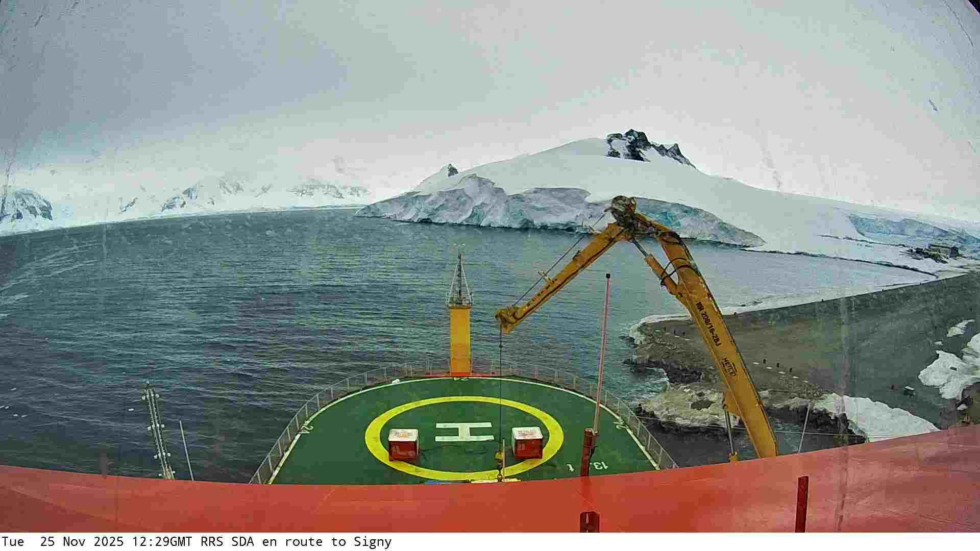 View of snow-covered hills under clear bright skies captured by a webcam mounted on the RRS Sir David Attenborough boat as it arrives in the Antarctic.