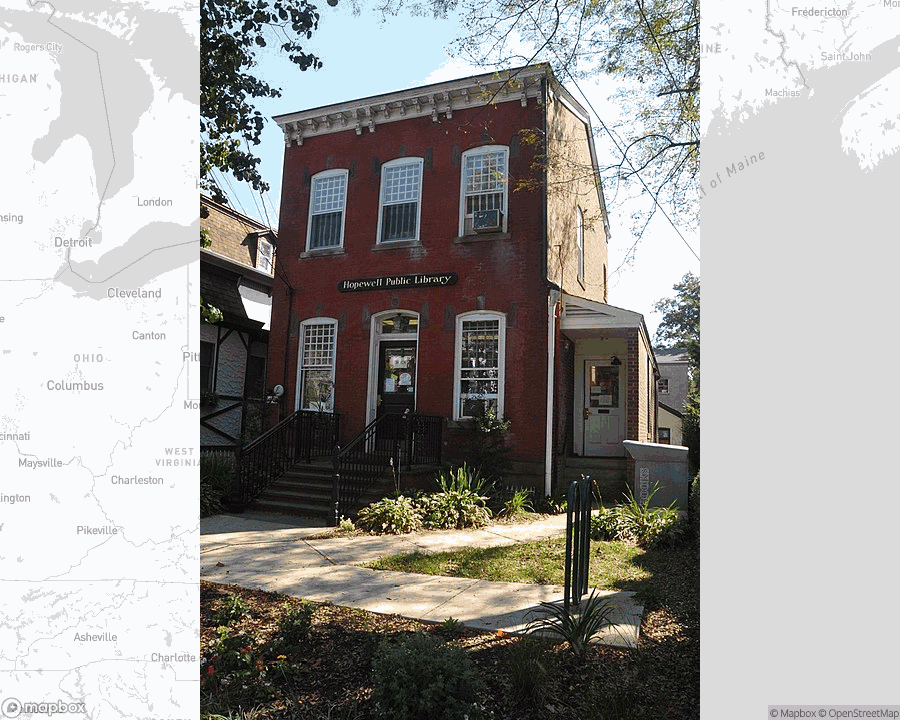 A photo of or from a library from the linked website, overlaid on a cropped world map where it's located.