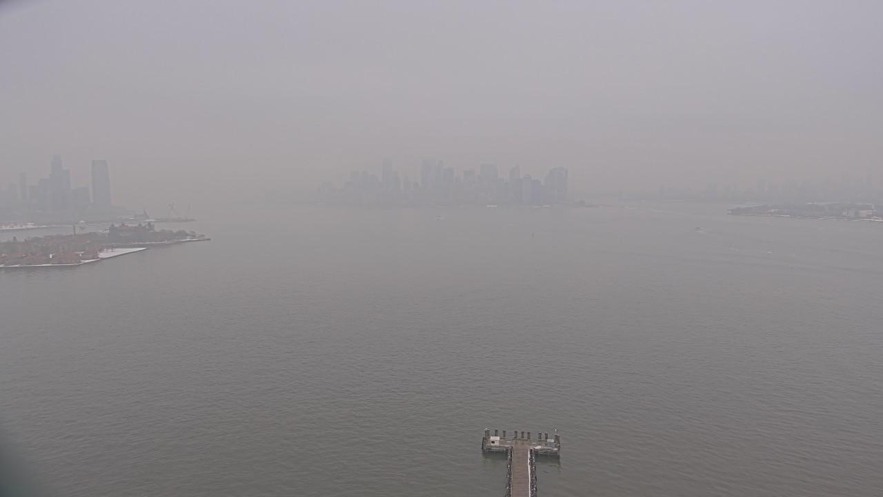 This webcam usually shows a distant view of Lower Manhattan from the Ellis Island. It's misty. It's 38ºF/3ºC.