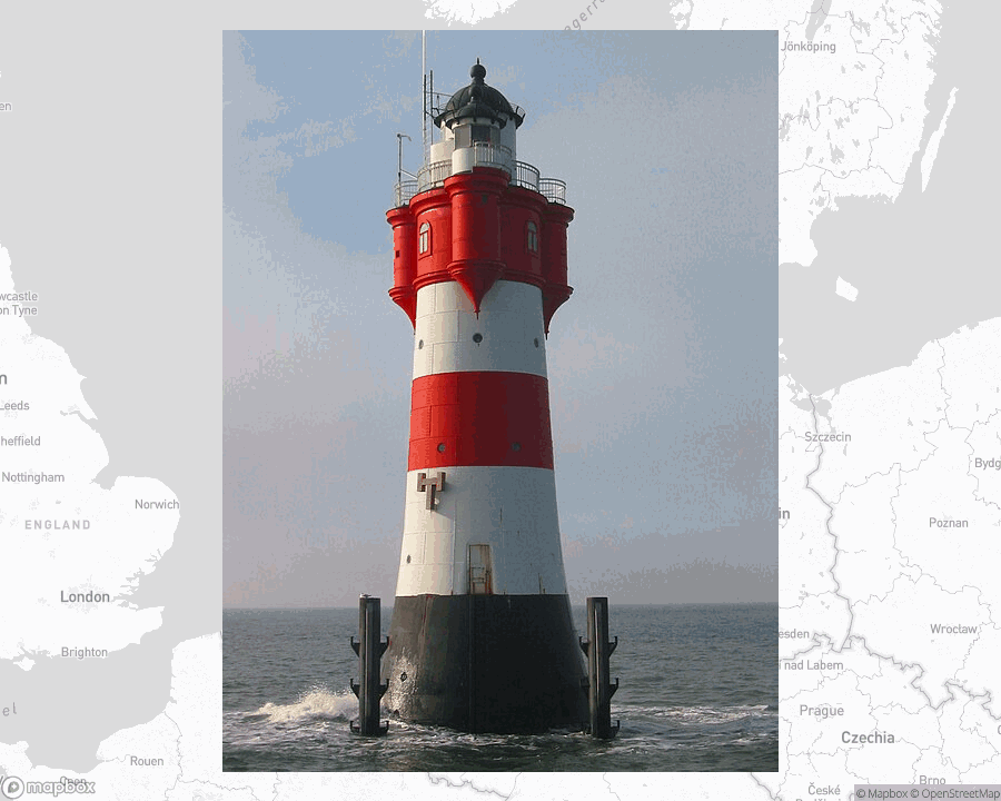 A photo of a lighthouse from the linked website, overlaid on a cropped world map where it's located.