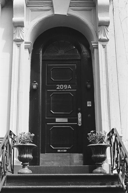 A 1976 black-and-white photo of a doorway in New York.